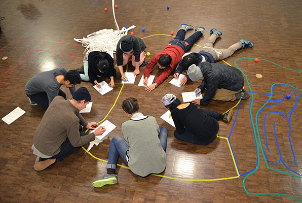 photograph of workshop participants making visual guides for performance